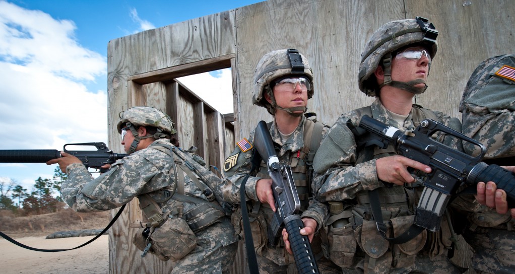 [McClatchy-Tribune Media Services] Private second class Autumn Ladines, left, specialist Rebecca Hill, center, and private first class Kristan Beard learn urban assault tactics training at Fort Jackson in Columbia, South Carolina, Jan. 30, 2013.
