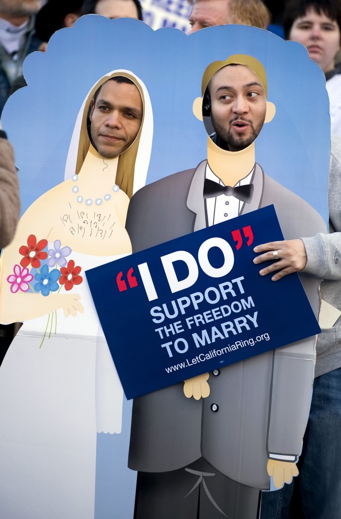 Luis Guerra and Walter Recinos, who were not married, stood in a cutout of a married couple as opponents to Proposition 8 gathered March 4, 2009, for a protest before the Supreme Court was set to hear arguments to overturn Prop. 8.
