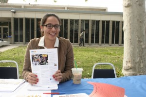 Mariana Vega, 19, handing out transfer fliers at the ASCC booth during Club Rush. 