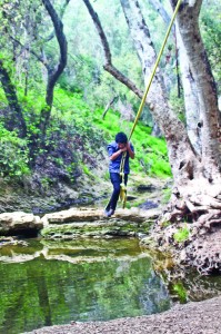 Liberal arts major Jose Guillen, 21, swings away during a hike at Walnut Creek in San Dimas.