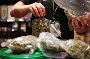 Assistant manager Dunn Ericson refills a jar of medical marijuana at the River Rock Medical Marijuana Center in Denver, Colorado, on May 16, 2013. (Anthony Souffle/Chicago Tribune/MCT)