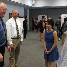 Susan Vong, 21, discussing her summer research on gravitational waves with faculty members, which was performed at CSUF. 