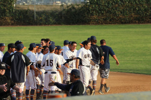 Dominic Baca (right) emerges from the celebration mob after his game-winning hit. The Owls defeated San Bernadino Valley College 7-6 on Feb. 23. 
