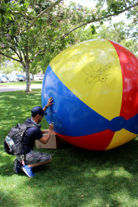 Communications major Matthew Luna wrote on the large free speech beach ball in the Campus center Mal on April 25, responding to a message claiming "Socialism is low key Communism." He added "when its right winged, the Fire Department is a socialist program. Question all aspects of Democracy and form your own opinion."