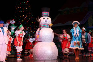 The Citrus singers perform with a life-sized Frosty the Snowman on Nov. 28 at the Haugh Performing Arts Center. The snowman was created using disco balls from a previous production. Photo by John Michaelides.